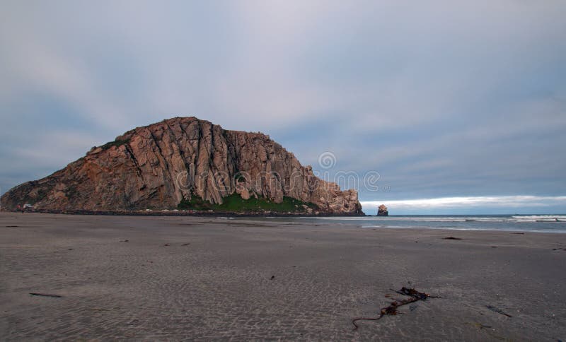 Morro Rock at sunrise under cumulus clouds at Morro Bay State Park camping...