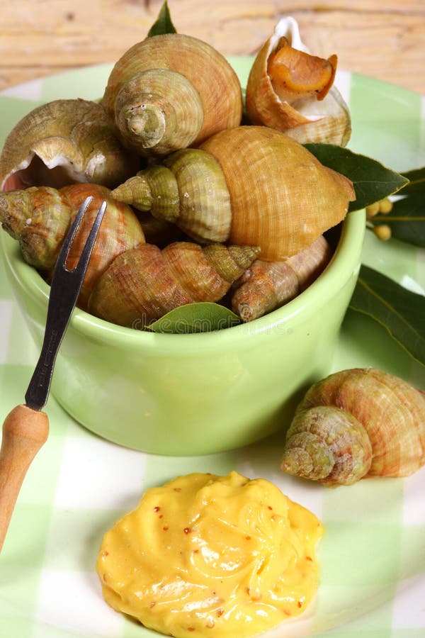 Whelks (bulot) or sea snails with mayonnaise in a French seafood restaurant. Whelks (bulot) or sea snails with mayonnaise in a French seafood restaurant