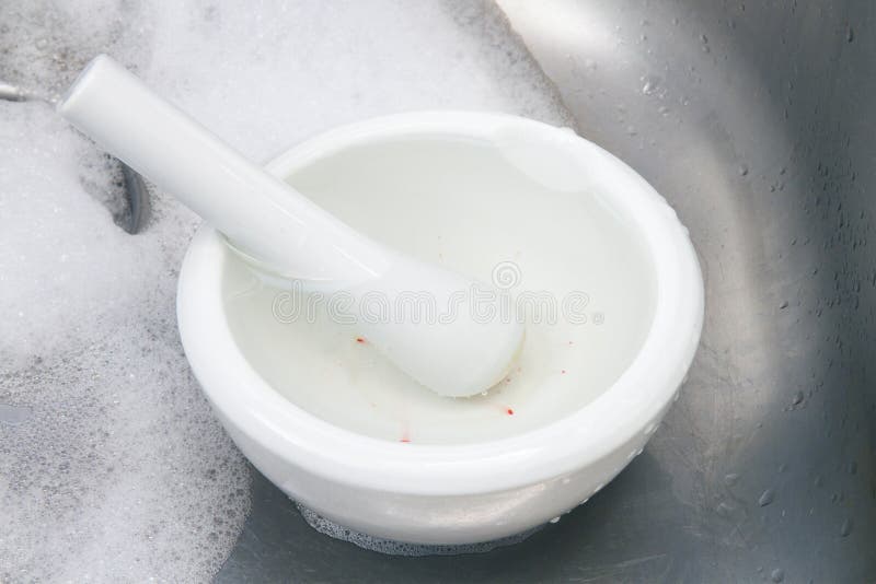 Mortar and Pestle Being Cleaned in an Aluminum Sink Stock Photo Image