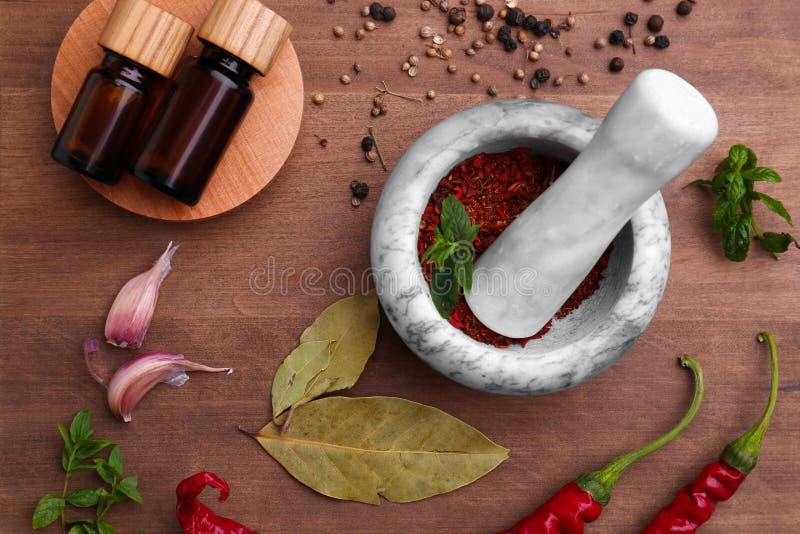 Mortar with Pestle, Bottles of Essential Oils and Different Ingredients