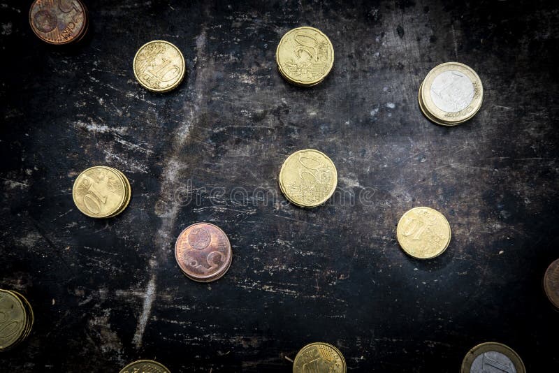 Regular pattern made up of euro coins on a dark black background with ripped metal details