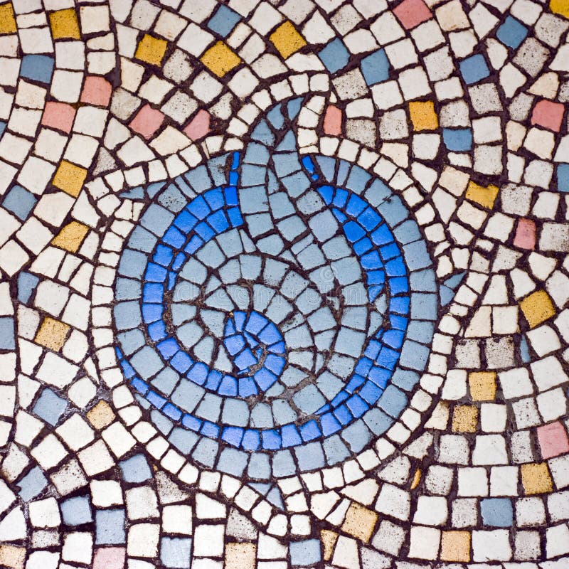 A close up of a colourful old mosaic with a circle in the middle. A close up of a colourful old mosaic with a circle in the middle