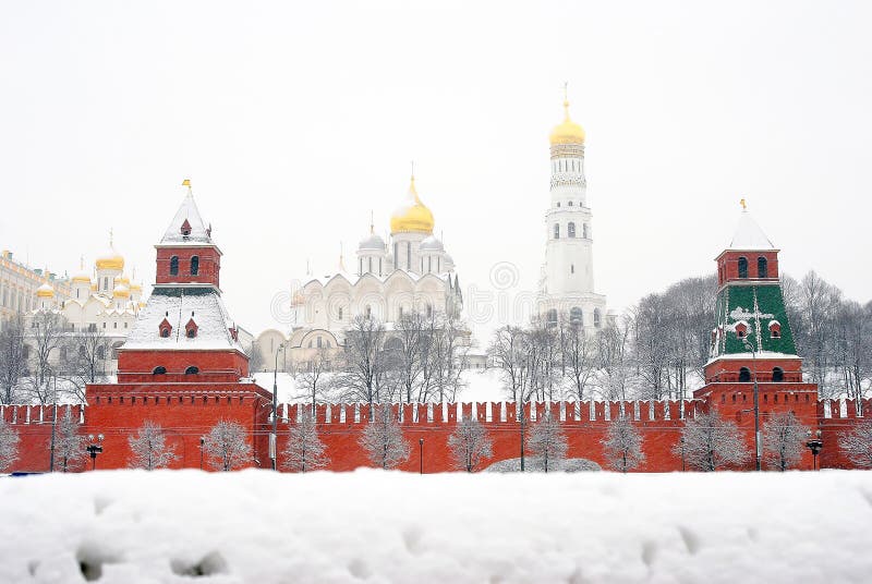 Moscow Kremlin panorama seen through the snow border. Russian winter. Archangels church, Ivan the Great Bell tower, Annunciation church, two towers covered by the snow. Moscow Kremlin panorama seen through the snow border. Russian winter. Archangels church, Ivan the Great Bell tower, Annunciation church, two towers covered by the snow.