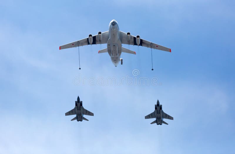 MOSCOW, RUSSIA - MAY 9, 2015:Russian Air Force IL-78 air-to-air refueling tanker demonstrates in-flight refueling of Mikoyan MiG-31 strategic bomber during for Victory Day military parade. MOSCOW, RUSSIA - MAY 9, 2015:Russian Air Force IL-78 air-to-air refueling tanker demonstrates in-flight refueling of Mikoyan MiG-31 strategic bomber during for Victory Day military parade