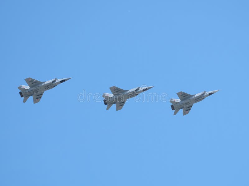 MOSCOW, RUSSIA - May 9, 2018: Group of Russian military supersonic high-altitude all-weather long-range interceptor MIG-31 Foxhound in flight in the blue sky on parade on May 9, 2018. MOSCOW, RUSSIA - May 9, 2018: Group of Russian military supersonic high-altitude all-weather long-range interceptor MIG-31 Foxhound in flight in the blue sky on parade on May 9, 2018