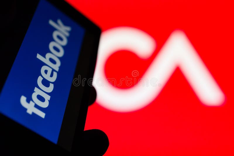 MOSCOW, RUSSIA - MAY 9, 2018: Smartphone in hand with logo of popular social network Facebook. Cambridge Analytica emblem in background. General Data Protection Regulation GDPR concept. Censorship. MOSCOW, RUSSIA - MAY 9, 2018: Smartphone in hand with logo of popular social network Facebook. Cambridge Analytica emblem in background. General Data Protection Regulation GDPR concept. Censorship