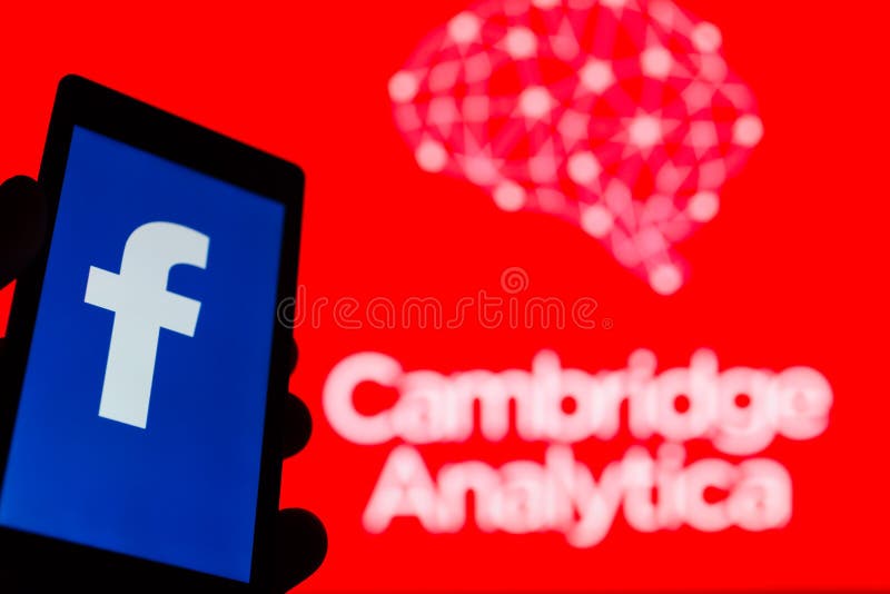 MOSCOW, RUSSIA - MAY 9, 2018: Smartphone in hand with logo of popular social network Facebook. Cambridge Analytica emblem in background. General Data Protection Regulation GDPR concept. Censorship. MOSCOW, RUSSIA - MAY 9, 2018: Smartphone in hand with logo of popular social network Facebook. Cambridge Analytica emblem in background. General Data Protection Regulation GDPR concept. Censorship