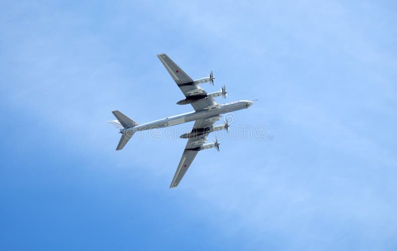 MOSCOW, RUSSIA - MAY 9, 2018: Big Russian military turboprop strategic bomber-missile Tu-95 Bear in flight in the sky on parade on May 9, 2018. MOSCOW, RUSSIA - MAY 9, 2018: Big Russian military turboprop strategic bomber-missile Tu-95 Bear in flight in the sky on parade on May 9, 2018