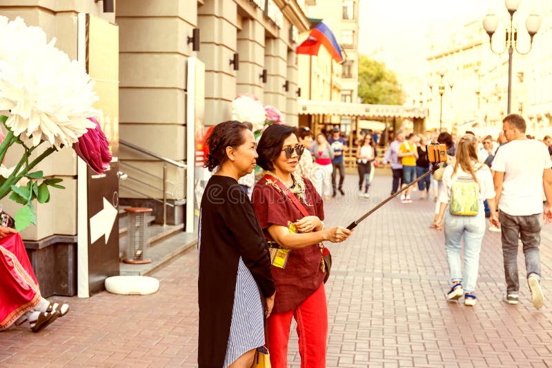 Two adult asian women taking a selfie using smartphone royalty free stock image Two adult asian women taking a selfie using smartphone royalty free stock image