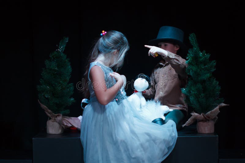 Moscow region / Russia - 01 06 2019: Puppet theater with Moomin trolls. Boy and girl playing with Moomin Troll dolls. Performance