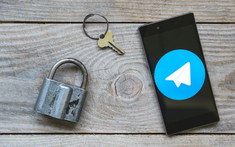 Icon of the Telegram messenger on the smartphone screen with a lock and a key