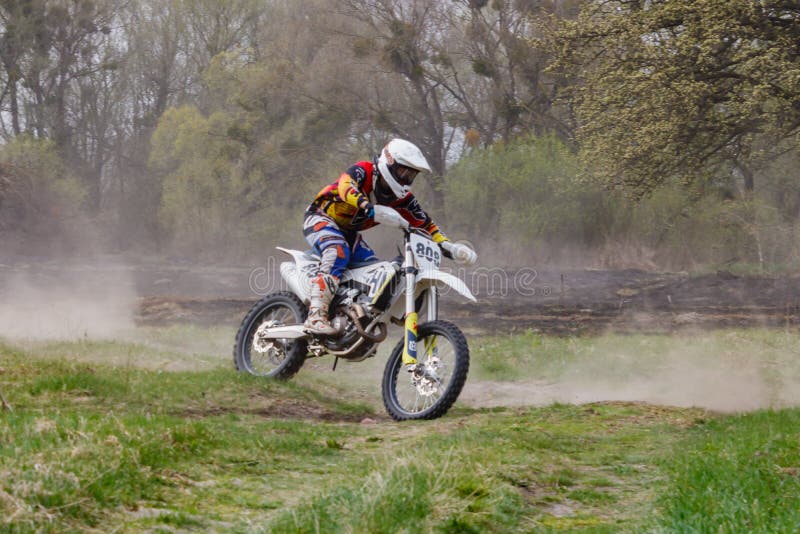 Moscow, Russia - April 13, 2019: Racer on a motocross bike rushes along a dirt track. Training of motocross sports team stock photo Moscow, Russia - April 13, 2019: Racer on a motocross bike rushes along a dirt track. Training of motocross sports team stock photo