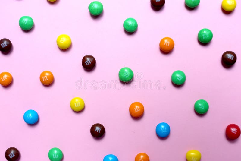 Moscow, Russia - August 1, 2019 : Image of colored mini m m candies. M M's background, isolated, easter, mm, sweet, pattern, chocolate, macro, objects, shiny, variation, vibrant, mars, studio, backdrop, close, christmas, frame, party, food, texture, kid, birthday, candy, brown, circle, closeup, dessert, green, orange, yellow, button, coated, colorful, milk, white, bright, group, snack, sugar, brand, blue, decoration. Moscow, Russia - August 1, 2019 : Image of colored mini m m candies. M M's background, isolated, easter, mm, sweet, pattern, chocolate, macro, objects, shiny, variation, vibrant, mars, studio, backdrop, close, christmas, frame, party, food, texture, kid, birthday, candy, brown, circle, closeup, dessert, green, orange, yellow, button, coated, colorful, milk, white, bright, group, snack, sugar, brand, blue, decoration