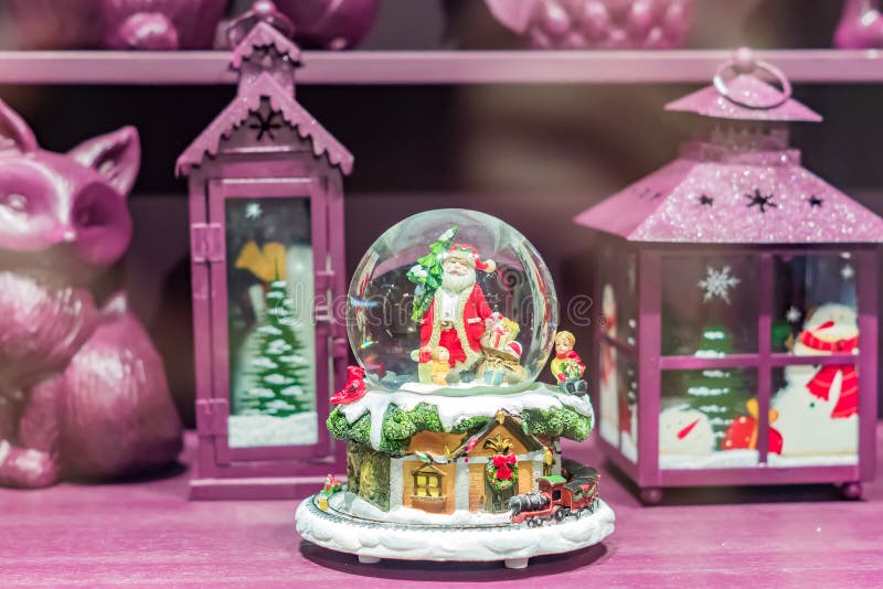 Moscow, Russia - January, 10, 2018 - Window shop with christmas gifts in GUM store. Snow globe with Santa and lanterns in purple