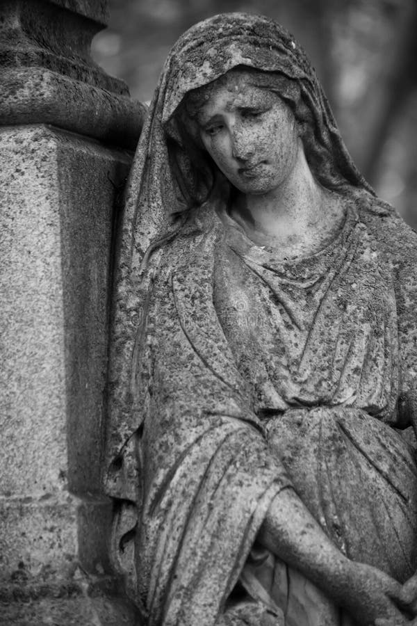 Grieving Angel Against A Background Of Dark Green Foliage Stock Image ...