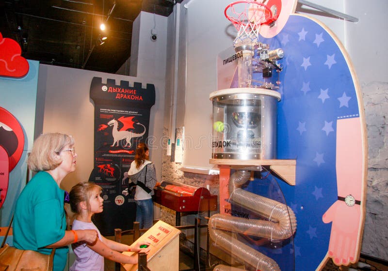 MOSCOW, RUSSIA - JULY 18, 2016: Visitors look at the physical model of the human digestive tract at the Human Living Systems museum in Moscow, Russia on July 18, 2016. MOSCOW, RUSSIA - JULY 18, 2016: Visitors look at the physical model of the human digestive tract at the Human Living Systems museum in Moscow, Russia on July 18, 2016