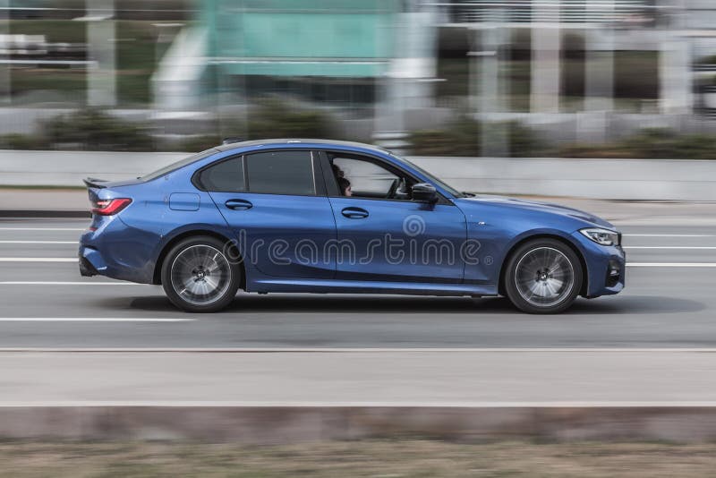 Moscow , Russia - March 2021: Blue BMW M3 series car on the city road. Fast moving vehicle on the street. Sedan driving along the street in city with blurred background. Moscow , Russia - March 2021: Blue BMW M3 series car on the city road. Fast moving vehicle on the street. Sedan driving along the street in city with blurred background