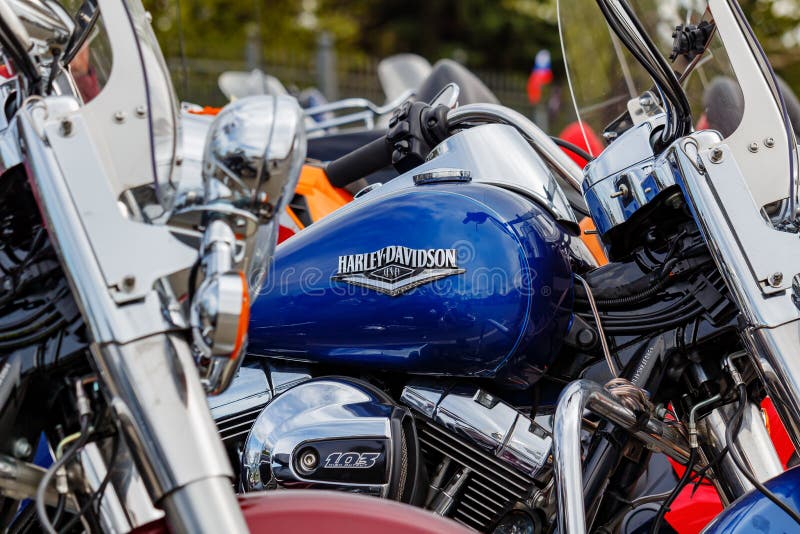 Moscow, Russia - May 04, 2019: Blue fuel tank of Harley Davidson motorcycle with emblem and chrome engine closeup. Moto festival