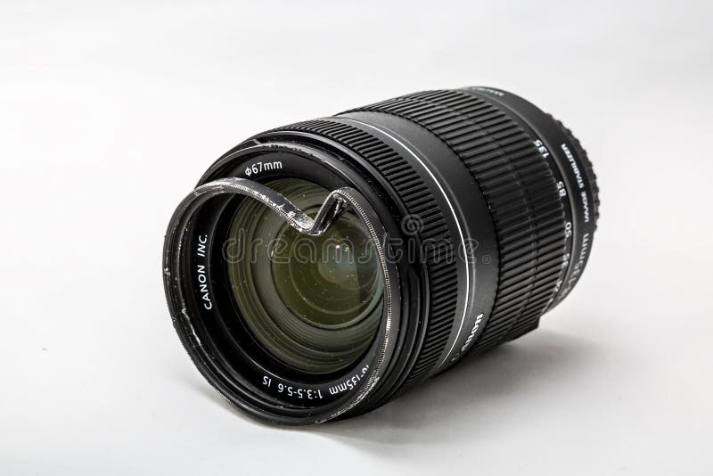 Moscow, Russia - May 13, 2019: Canon zoom tele foto lens 18-135mm with a broken protective glass filter on a white background. stock images Moscow, Russia - May 13, 2019: Canon zoom tele foto lens 18-135mm with a broken protective glass filter on a white background. stock images
