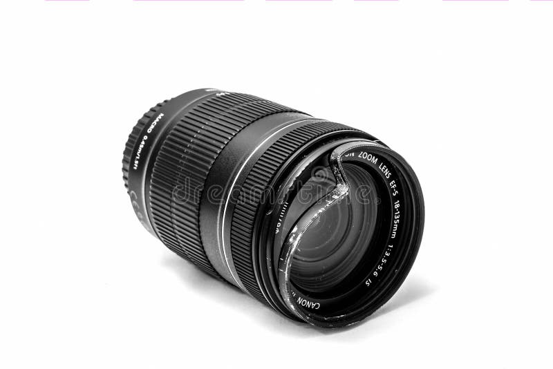 Moscow, Russia - May 13, 2019: Canon zoom tele foto lens 18-135mm with a broken protective UV glass filter on a white background. stock image Moscow, Russia - May 13, 2019: Canon zoom tele foto lens 18-135mm with a broken protective UV glass filter on a white background. stock image