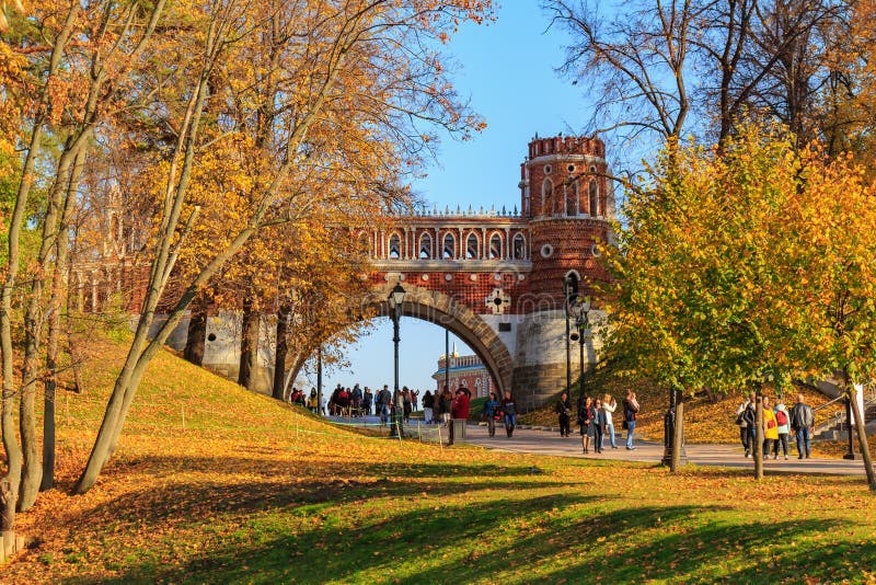 Moscow, Russia - October 17, 2018: Figured bridge on a background of blue sky and green lawn at sunny autumn day in Tsaritsyno park in Moscow