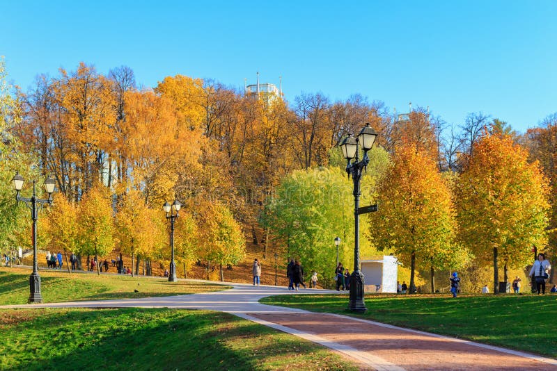 Moscow, Russia - October 17, 2018: Tourists walking on alleys at sunny autumn day in Tsaritsyno park in Moscow