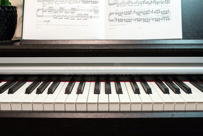 An Open Book of Sheet Music on the Piano. a Composition of the Sheet