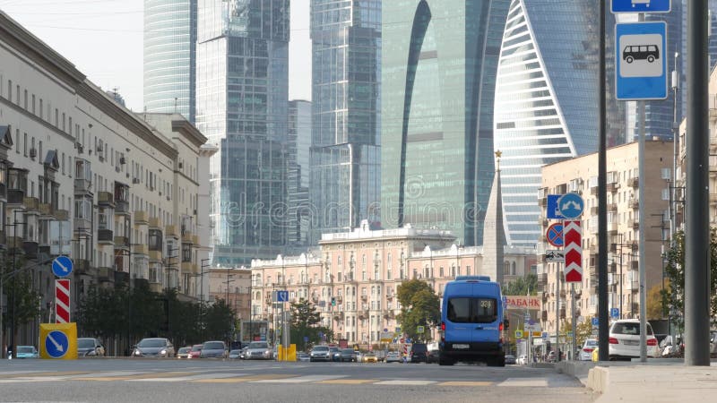 Pedestrians on zebra, people crossing road on crosswalk. Moscow city street.