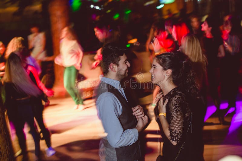 MOSCOW, RUSSIAN FEDERATION - OCTOBER 13, 2018: A middle-aged couple, a man and a woman, dance salsa among a crowd of dancing peopl stock photo MOSCOW, RUSSIAN FEDERATION - OCTOBER 13, 2018: A middle-aged couple, a man and a woman, dance salsa among a crowd of dancing peopl stock photo