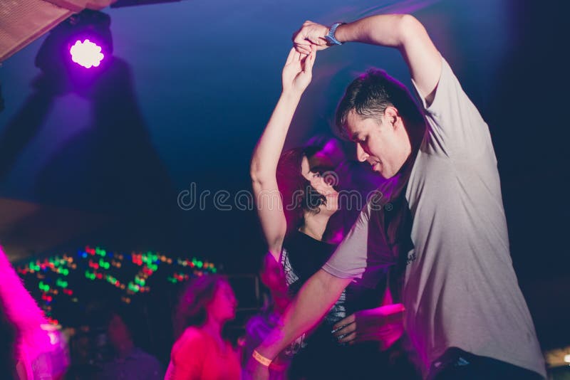 MOSCOW, RUSSIAN FEDERATION - OCTOBER 13, 2018: A middle-aged couple, a man and a woman, dance salsa among a crowd of dancing peopl royalty free stock photo MOSCOW, RUSSIAN FEDERATION - OCTOBER 13, 2018: A middle-aged couple, a man and a woman, dance salsa among a crowd of dancing peopl royalty free stock photo