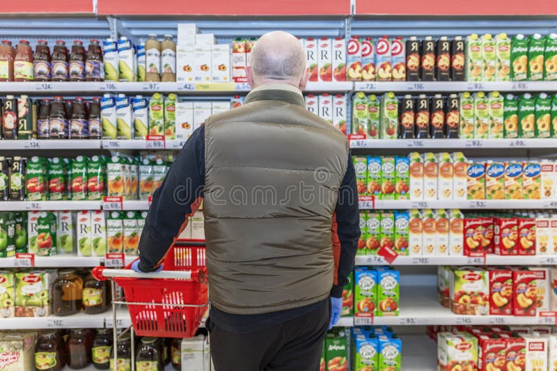 Moskau Russland 07042020 : ein Nirgendwo Mann wählt Fruchtsäften in einem Geschäft. ein großes Sortiment. Rück Ansicht lizenzfreies stockbild