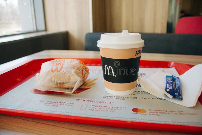 Moskau, Russland - 11 18 2018: Hamburgermenü in Mcdonald-Restaurant, Kaffee, Cheeseburger Fastfood, Konzept der ungesunden Fertig lizenzfreie stockfotografie Moskau, Russland - 11 18 2018: Hamburgermenü in Mcdonald-Restaurant, Kaffee, Cheeseburger Fastfood, Konzept der ungesunden Fertig lizenzfreie stockfotografie