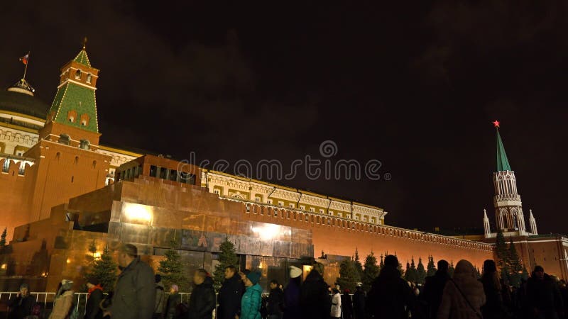 MOSKWA ROSJA, STYCZEŃ, -, 2, 2017 Turyści chodzą przeciw iluminującemu Kremlin ściany i Lenin ` s mauzoleumowi na rewolucjonistce fotografia stock MOSKWA ROSJA, STYCZEŃ, -, 2, 2017 Turyści chodzą przeciw iluminującemu Kremlin ściany i Lenin ` s mauzoleumowi na rewolucjonistce fotografia stock