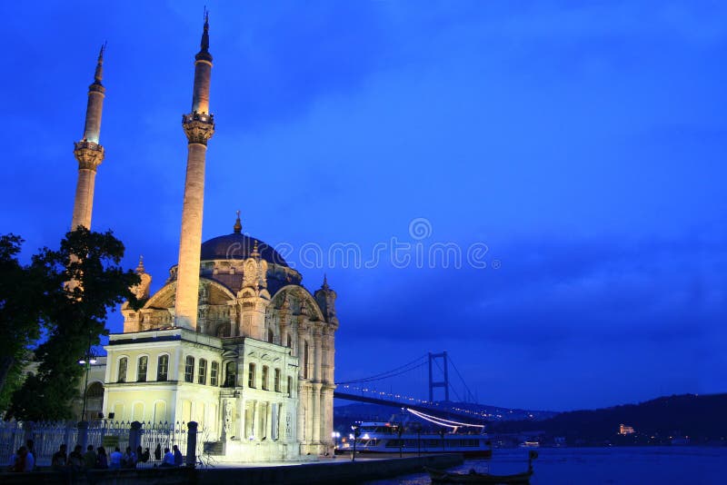 It is in Boğaziçi (Bosphorus) in Ortaköy district, by the coast. The mosque was commissioned in 153 by Sultan Abdülmecid to Architect Nigoğos Balyan. The mosque which has a rather elegant structure is of Baroque style. It is placed in an unparalleled location in Bosphorus. As in all mosques built by the sultan, it is made up of two parts of harem and sultan’s office. Wide and high windows are arranged in a way to carry the changing lights of Bosphorus inside the mosque. The stair cased building has two minarets with single balcony each. The walls are made of white hewn stone. The walls of the single dome are made of pink mosaics. The mihrab again is made of mosaics and marble and the mimbar is made of porphyry coated marble, all products of an elegant workmanship. It is in Boğaziçi (Bosphorus) in Ortaköy district, by the coast. The mosque was commissioned in 153 by Sultan Abdülmecid to Architect Nigoğos Balyan. The mosque which has a rather elegant structure is of Baroque style. It is placed in an unparalleled location in Bosphorus. As in all mosques built by the sultan, it is made up of two parts of harem and sultan’s office. Wide and high windows are arranged in a way to carry the changing lights of Bosphorus inside the mosque. The stair cased building has two minarets with single balcony each. The walls are made of white hewn stone. The walls of the single dome are made of pink mosaics. The mihrab again is made of mosaics and marble and the mimbar is made of porphyry coated marble, all products of an elegant workmanship.