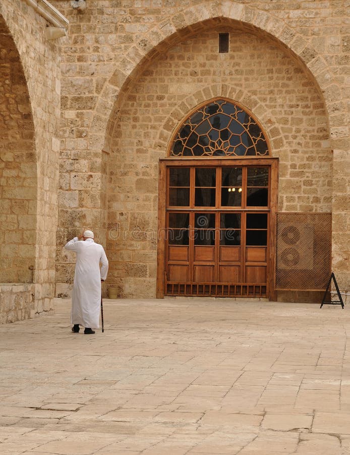 Old muslim men walking inside a mosque. Old muslim men walking inside a mosque.