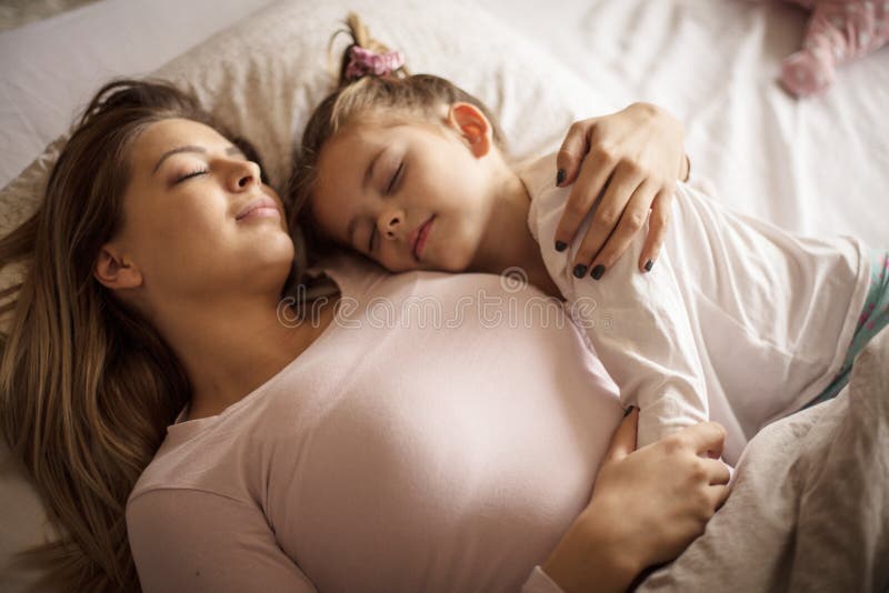 Mother and daughter sleeping together.