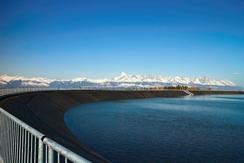 The most famous Slovak peak in the High Tatras - Krivan. A view of the Cierny Vah hydroelectric power plant