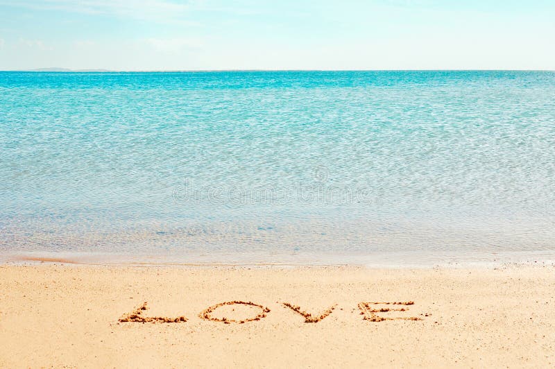 "Love" word written on the beach near the sea. "Love" word written on the beach near the sea