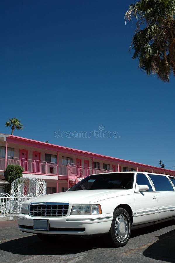 A cheap looking pink motel and a white limousine ready for the next wedding in Las Vegas. A cheap looking pink motel and a white limousine ready for the next wedding in Las Vegas.