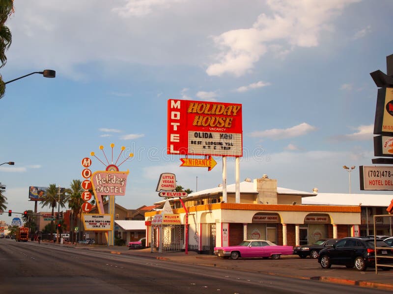 LAS VEGAS, NEVADA - JULY 20, 2018: The vintage Holiday House Motel and the Little Vegas Chapel, with its two pink Cadillacs, on Las Vegas Boulevard, on a sunny day. LAS VEGAS, NEVADA - JULY 20, 2018: The vintage Holiday House Motel and the Little Vegas Chapel, with its two pink Cadillacs, on Las Vegas Boulevard, on a sunny day