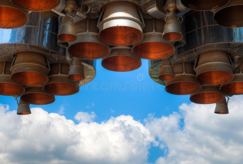 Details of space rocket engine against blue sky with clouds. Details of space rocket engine against blue sky with clouds