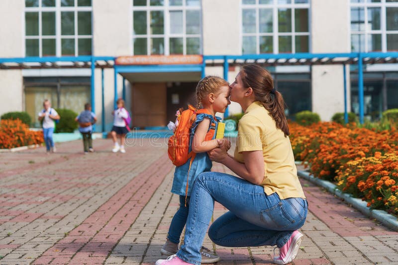 Mother accompanies the child to school stock photography