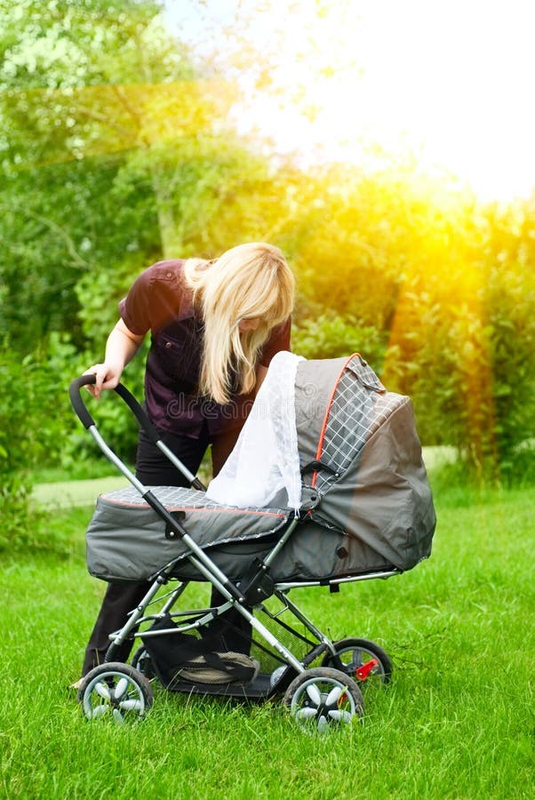 Mother with baby carriage royalty free stock photography