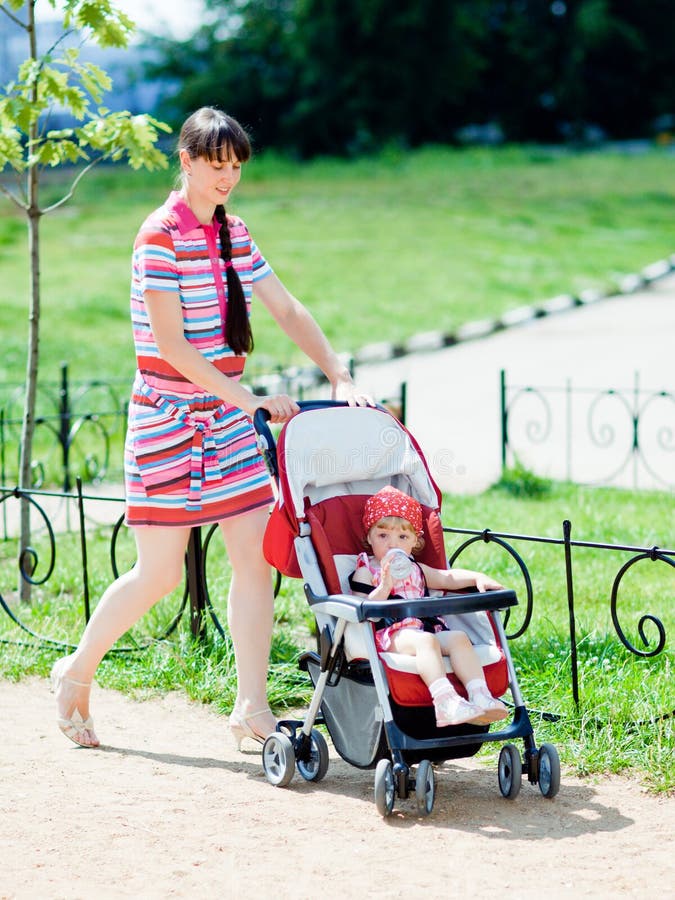 Mother with baby-carriage royalty free stock photo