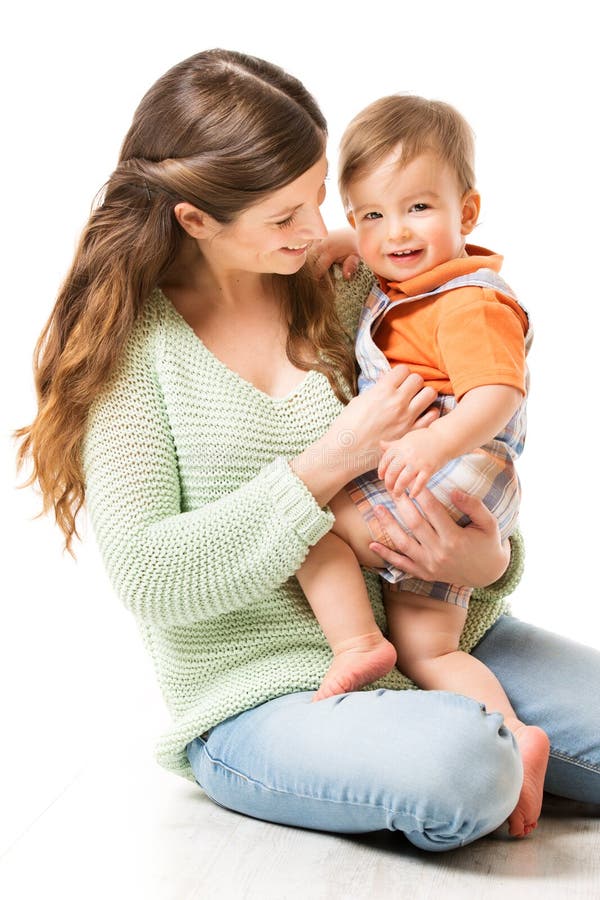 Mother and Baby, Happy Mom with Child one year old sitting on floor, Family on White royalty free stock images Mother and Baby, Happy Mom with Child one year old sitting on floor, Family on White royalty free stock images