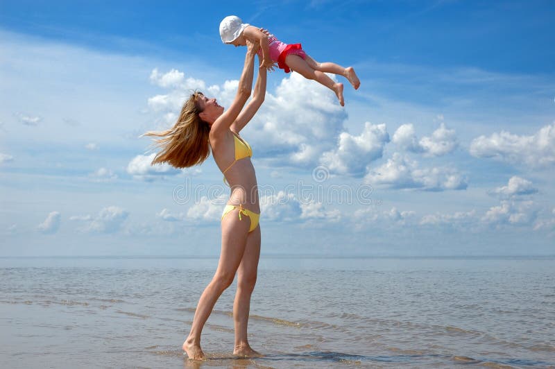 Mother and baby have fun on the beach