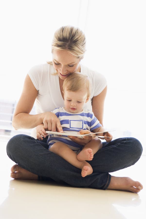 Mother and baby indoors reading book