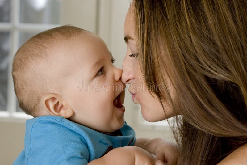 Mother and baby kissing and laughing