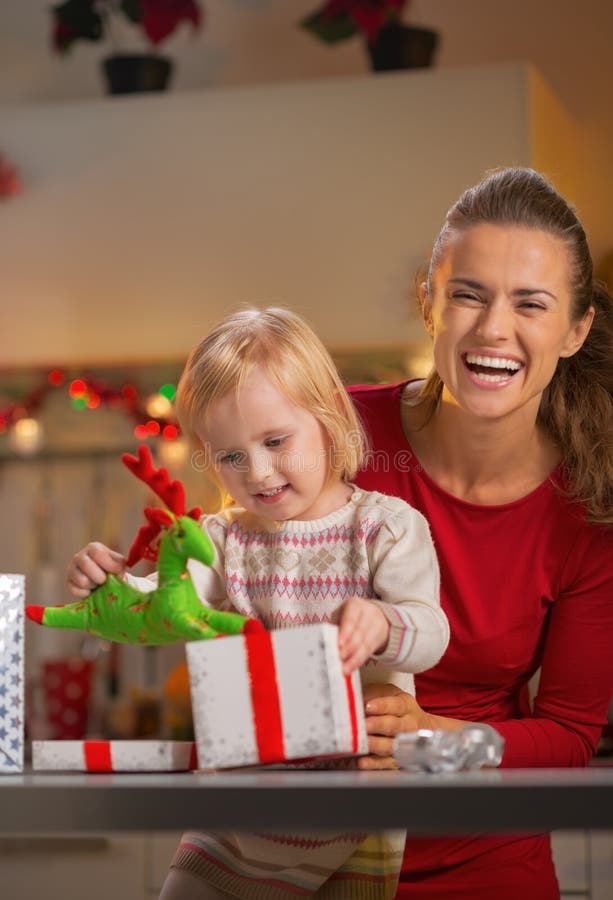 Mother and baby opening christmas present box royalty free stock images Mother and baby opening christmas present box royalty free stock images
