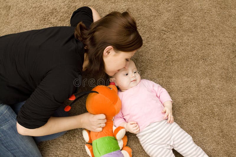 Mother and baby playing in home